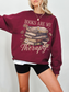 burgundy books are my therapy sweatshirt with coffee and floral book stack design worn by woman with blonde hair