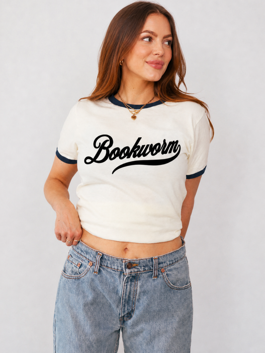 woman wearing grey and black ringer tee with bold bookish text graphic styled with relaxed denim jeans for book lover outfit