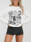 smiling model in white cats and books crewneck sweatshirt with detailed feline line art