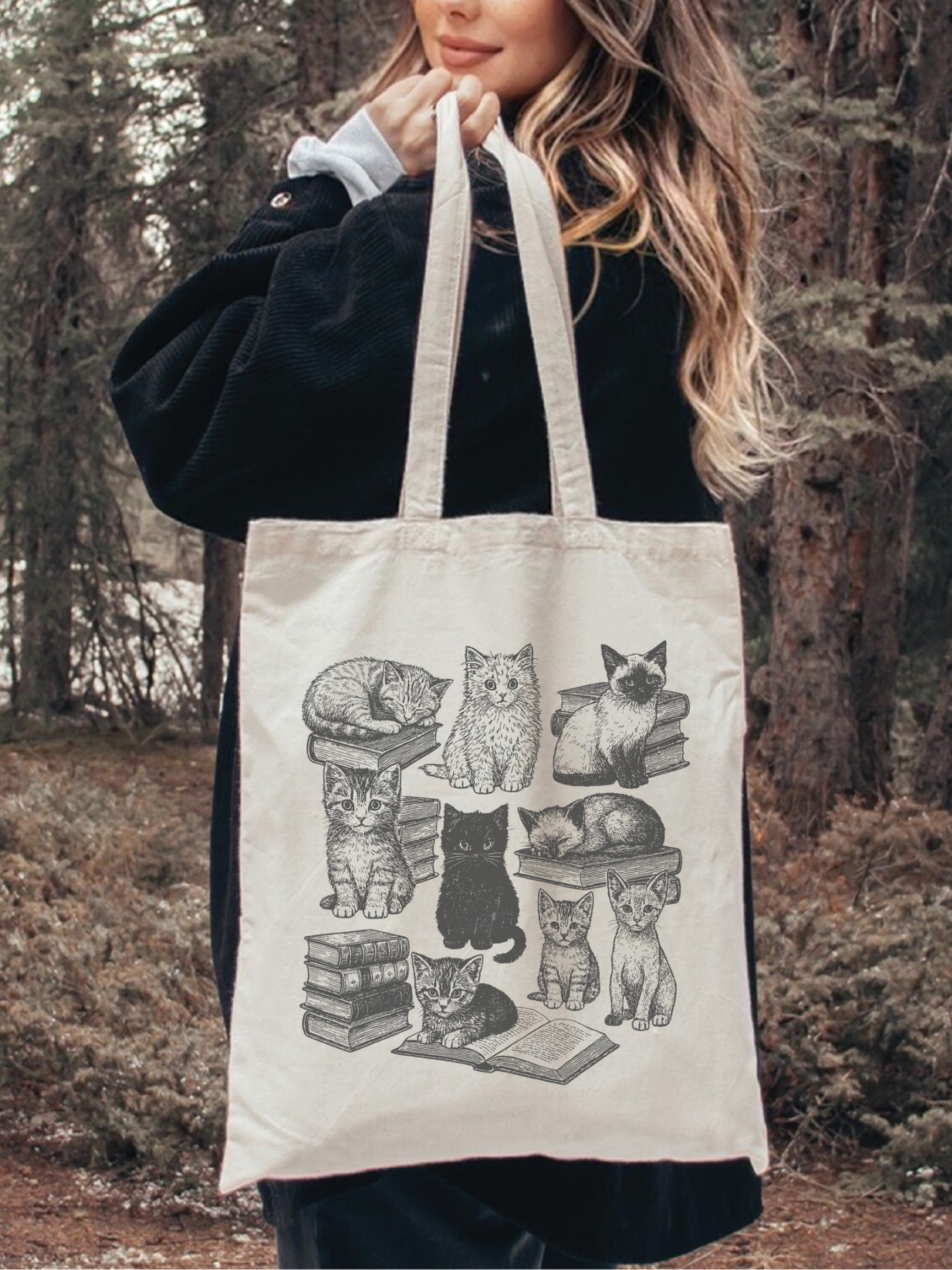 cozy reading tote bag with vintage cat illustration, modeled in forest setting with black coat