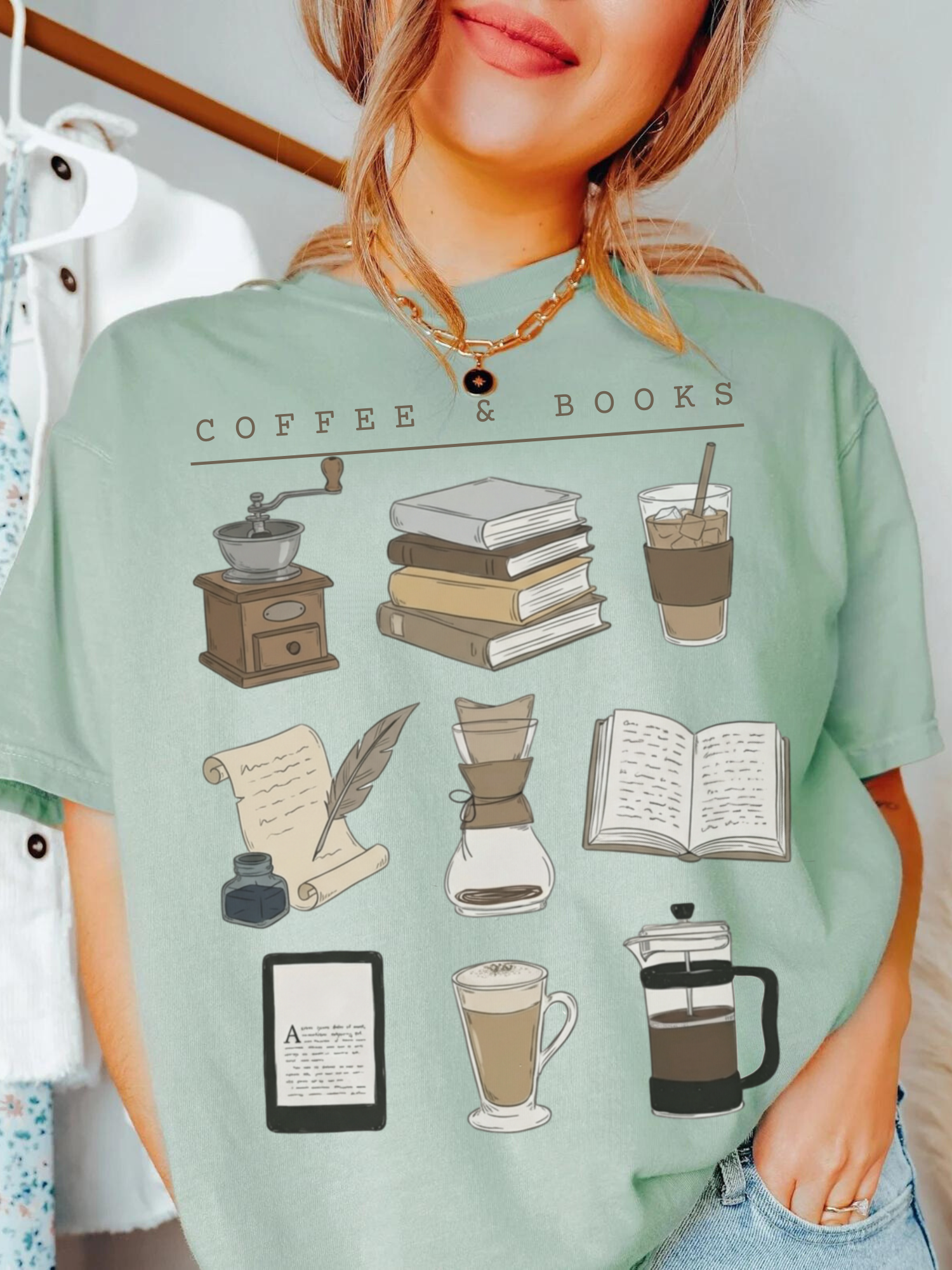 woman wearing green Comfort Colors coffee and books shirt with hand-drawn book stack and coffee illustrations
