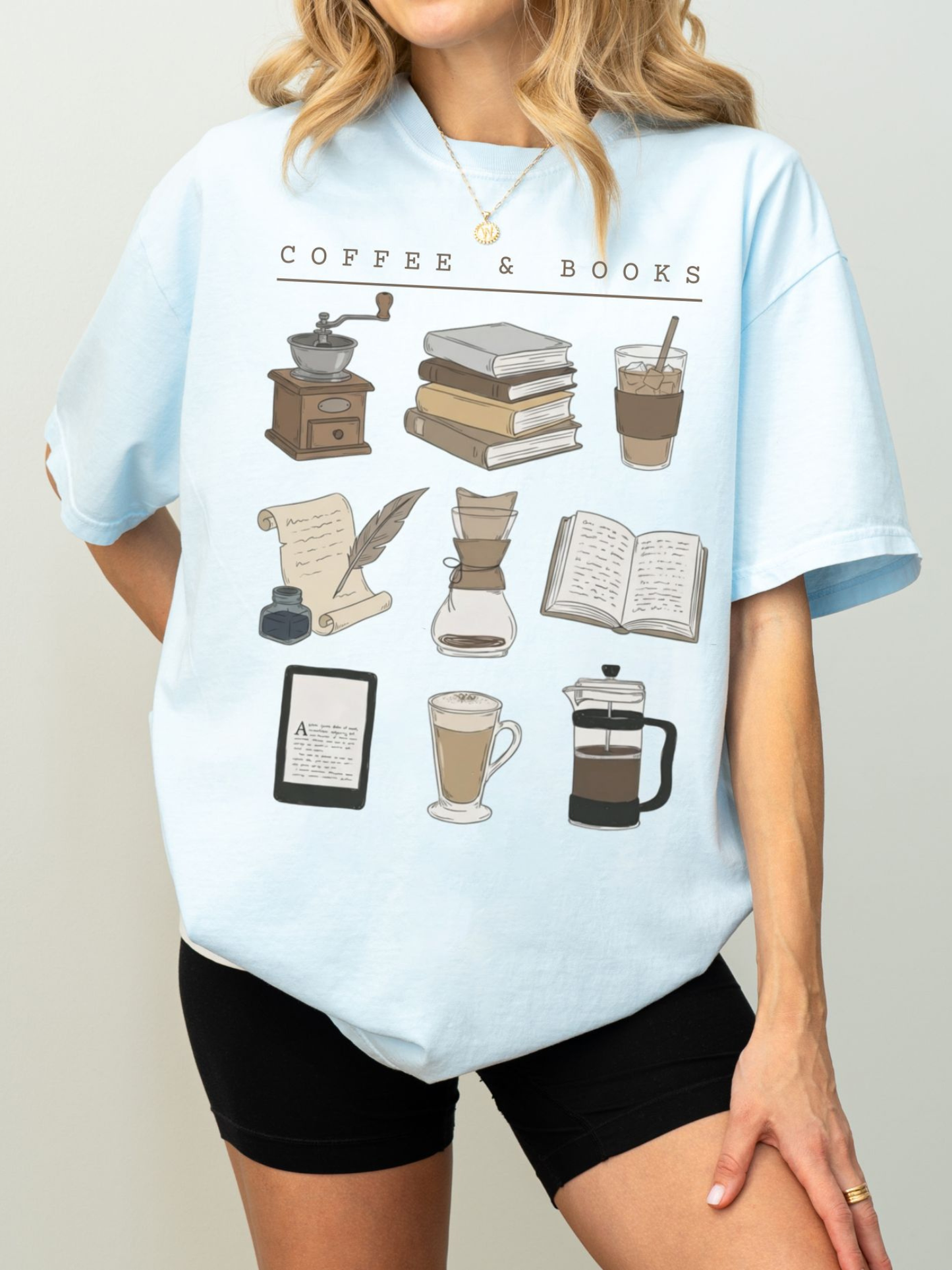 light blue Comfort Colors shirt with cozy reading and coffee illustrations on model