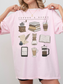 pink pastel reading shirt with coffee and books drawings, worn by blonde woman
