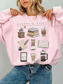 pink coffee and books crewneck sweatshirt worn by blonde woman with layered gold necklaces