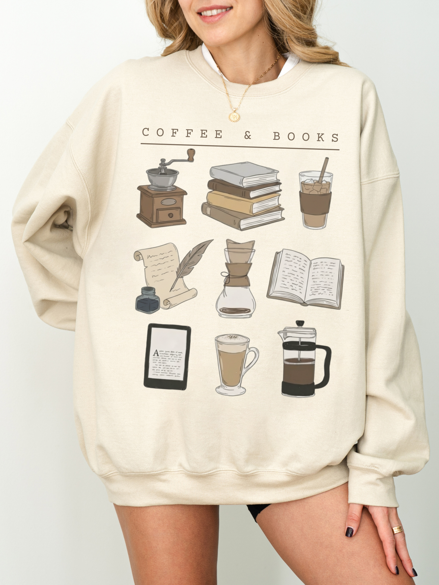 Sand sweatshirt styled with necklace and cozy book and coffee icons including iced coffee and French press