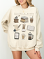 Sand sweatshirt styled with necklace and cozy book and coffee icons including iced coffee and French press