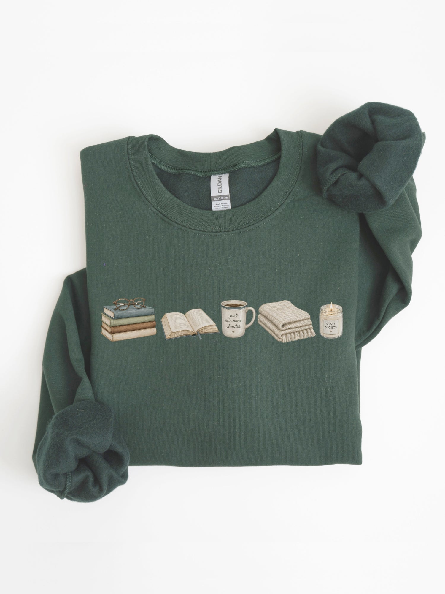 Folded forest green Gildan reading sweatshirt with books, coffee mug, cozy blanket and candle design