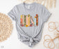 flatlay of athletic heather grey shirt with pastel floral bookshelf design and customizable book spines