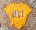 flatlay of gold t-shirt with custom book shelf graphic featuring pastel flowers and titles