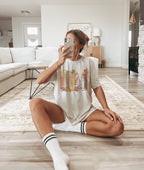 woman sitting on floor in natural custom bookshelf shirt showing pastel floral book spines
