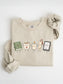 Gildan book lover sweatshirt with cute book, coffee mug, candle, bookmark and e-reader characters in Sand