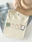 Comfort Colors reading shirt featuring cute book, coffee mug, candle, bookmark and e-reader characters in Ivory