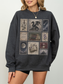 Woman wearing dark heather gray sweatshirt with fantasy postage stamp collage including dragon castle moon antique books flowers and romantic fantasy inspired artwork