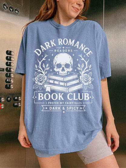 Model wearing a Blue Jean Comfort Colors bookish shirt featuring Dark Romance Readers Book Club text with skull, stacked books and roses graphic for dark romance readers