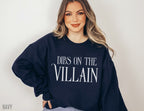 woman posing in navy Dibs on the Villain sweatshirt with soft waves and casual jeans