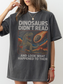 Woman wearing a pepper oversized t shirt with funny dinosaur graphic and text dinosaurs didnt read and look what happened to them meteor illustration