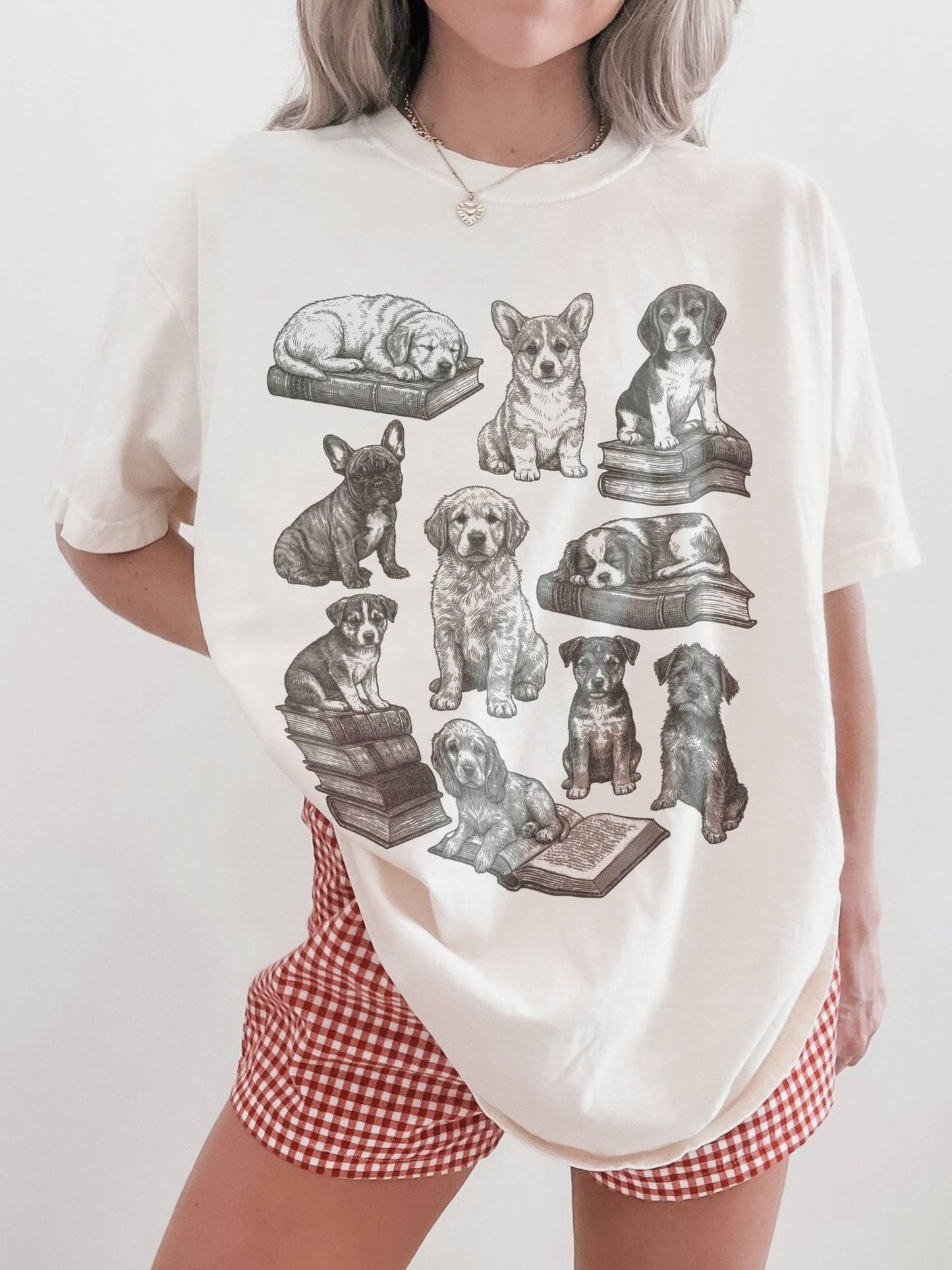 woman modeling cream t-shirt with vintage dog and book illustration, perfect for dog lovers who enjoy reading and cottagecore fashion
