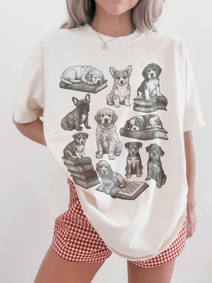 woman modeling cream t-shirt with vintage dog and book illustration, perfect for dog lovers who enjoy reading and cottagecore fashion
