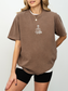 Espresso Comfort Colors book lover shirt with embroidered skeleton reading a book beside a cat