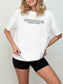 Model wearing a white Comfort Colors fantasy book shirt with “Ever Since I Was a Little Girl I Knew I Wanted to Read About Dragons and Magic” quote