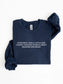A navy blue sweatshirt with white printed text on the chest reading 'EVER SINCE I WAS A LITTLE GIRL, I KNEW I WANTED TO READ ABOUT DRAGONS AND MAGIC', shown folded on a white background.