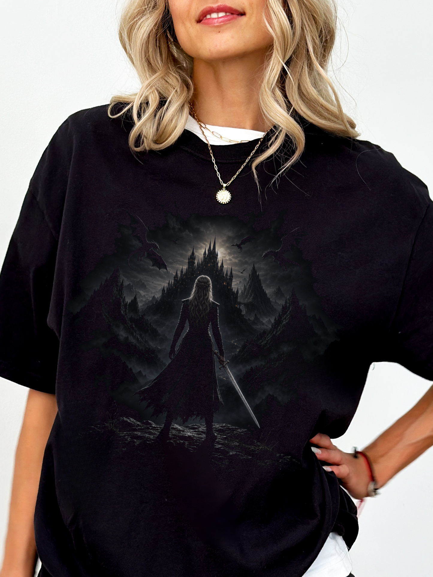 woman wearing a black fantasy dragon castle shirt with dark gothic warrior, dragons, and medieval castle graphic