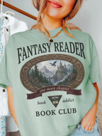 woman wearing a bay Comfort Colors Fantasy Reader Book Club shirt featuring a fantasy castle, dragon, mountains, and one more chapter design for fantasy book lovers