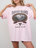 woman wearing a blossom Comfort Colors Fantasy Reader Book Club shirt with fantasy landscape artwork, dragon illustration, and one more chapter book lover design