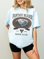 woman wearing a chambray Comfort Colors Fantasy Reader Book Club shirt featuring a castle, dragon, mountains, and fantasy reader graphic for bookworms