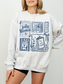model wearing gray fully booked book lover sweatshirt with illustrated reading design relaxed cozy casual outfit