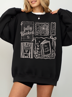woman wearing black fully booked book lover sweatshirt with vintage reading illustrations cozy oversized fit aesthetic