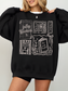 woman wearing black fully booked book lover sweatshirt with vintage reading illustrations cozy oversized fit aesthetic