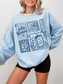 model wearing light blue fully booked book lover sweatshirt with cozy reading graphics styled casually with shorts