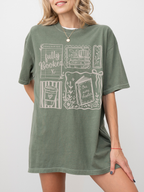 model wearing moss fully booked book lover t shirt with cozy reading themed graphics relaxed oversized fit