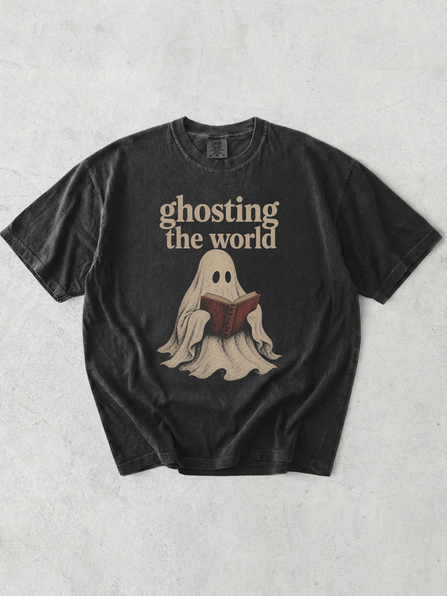 Graphite Comfort Colors bookish shirt with Ghosting the World text and vintage ghost reading a book graphic for readers and book lovers