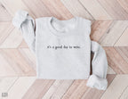folded ash grey sweatshirt with minimalist it's a good day to write text on wood background