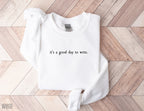 folded white sweatshirt with black minimalist text that says it's a good day to write