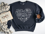 dark heather sweatshirt with white heart-shaped book design styled with coffee, blanket, and open book