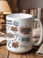White I Love You in Book Quotes coffee mug styled on wooden table with stacked books and warm lamp light featuring romance novel quotes and illustrated bookish icons