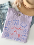 Orchid comfort colors bookish graphic t shirt flat lay with id rather be reading design beside denim jeans hat and jewelry accessories