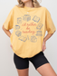 woman wearing mustard yellow oversized book lover shirt with id rather be reading graphic and illustrated books reading aesthetic artwork