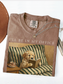 espresso comfort colors shirt with dog reading book design vintage painting style cozy reader aesthetic with coffee and neutral tones flatlay