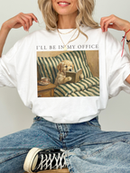 white oversized t shirt styled on model with dog reading book artwork and ill be in my office text cozy reader outfit aesthetic with jeans