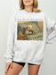 gray crewneck sweatshirt on model with vintage dog reading book graphic cozy reading aesthetic oversized fit casual outfit