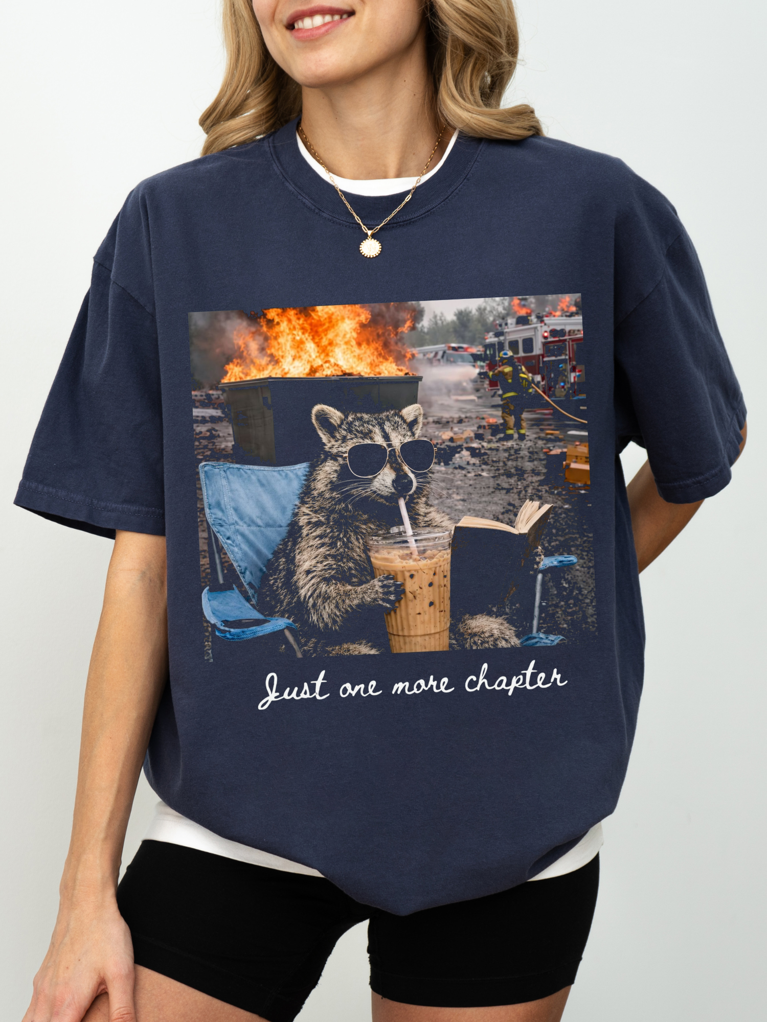navy comfort colors funny raccoon reading shirt with just one more chapter quote iced coffee and fire scene graphic