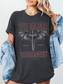 Dark heather grey Kejari Tournament t-shirt worn with denim jacket, featuring gothic-style dragon wings and fantasy sword illustration for romantasy fans.