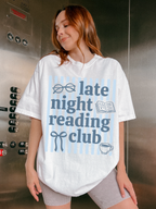 woman posing in elevator wearing late night reading club white t shirt with book lover design and blue stripe background graphic