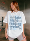 woman posing in elevator wearing late night reading club white t shirt with book lover design and blue stripe background graphic