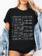 woman wearing a black t-shirt with vintage library stamp and bookish quote, styled with denim jacket