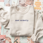 folded sand sweatshirt with minimalist most ardently quote styled on pastel photo background